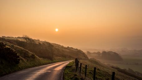Serene Sunrise on a Coastal Road wallpaper