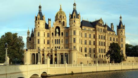 Majestic Castle by the River in an Enchanting Cityscape wallpaper