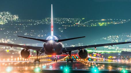 Nighttime Runway Drama With Breathtaking Aircraft View wallpaper