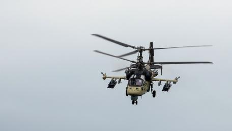 Powerful Helicopter in Flight Above the Clouds wallpaper