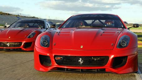 Red Ferraris Racing on Track wallpaper