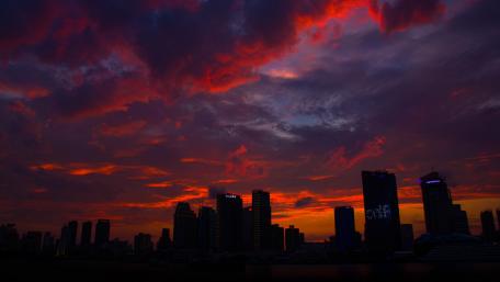 Dramatic Sunset Over City Skyline wallpaper