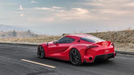 Sleek Elegance of a Red Sports Car in Nature wallpaper