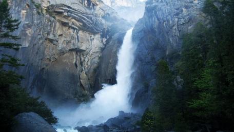 Majestic Waterfall in Tranquil Wilderness wallpaper