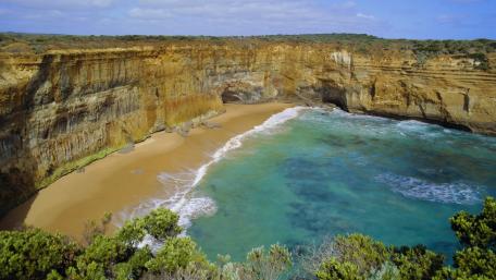 Majestic Cliffs Embracing Serene Waters wallpaper