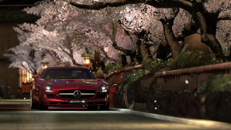 Elegant Red Sports Car Surrounded by Cherry Blossoms wallpaper