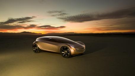 Futuristic Concept Car in a Desert Sunset Scene wallpaper