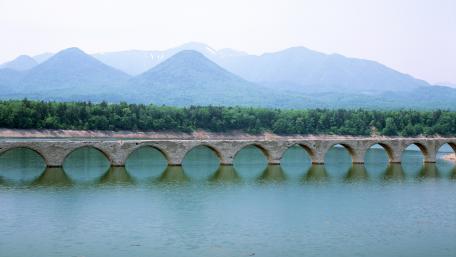 Serene Bridge Over Tranquil Waters in Nature wallpaper