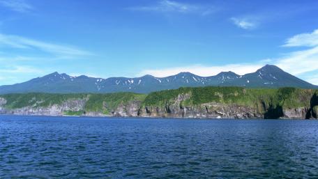 Majestic Coastal Mountains Under Clear Blue Sky wallpaper