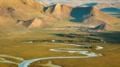Serene Landscape of Rolling Hills and Meandering River wallpaper