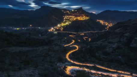 Serene Mountain Village Illuminated at Night wallpaper