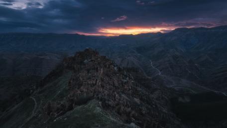 Majestic Mountain Fortress at Dusk wallpaper