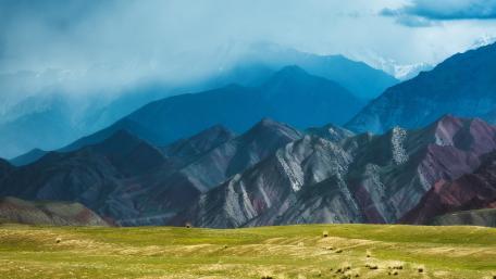 Majestic Mountain Ranges Beneath Cloudy Skies wallpaper
