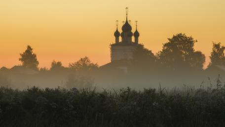 Misty Sunrise Over Ancient Architecture wallpaper