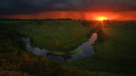 Serene Sunset Over Rolling Hills and River wallpaper