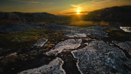 Serene Sunset Over Rocky Terrain wallpaper