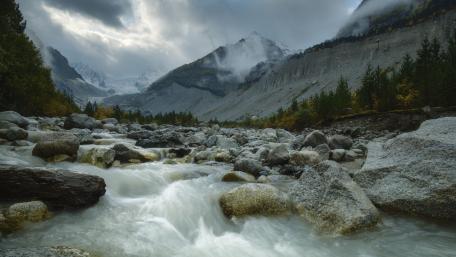Serene Mountain Stream in Tranquil Landscape wallpaper
