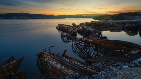 Haunting Beauty of Wrecked Ships at Sunset wallpaper