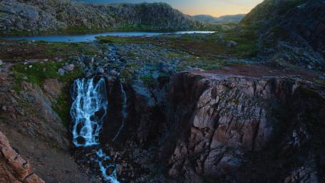 Majestic Waterfall Overlooking Serene Valley Landscape wallpaper