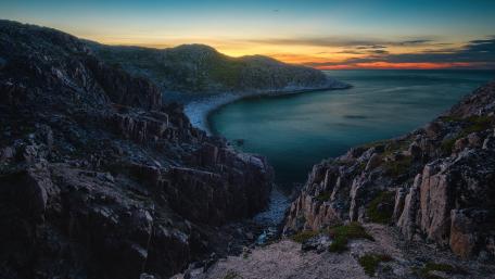 Serene Coastal Sunset Over Rugged Cliffs wallpaper