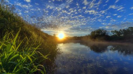 Tranquil Sunrise Over Serene River Scene wallpaper