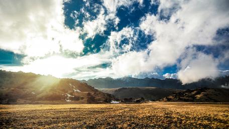 Majestic Mountain Range Under Cloudy Sky wallpaper