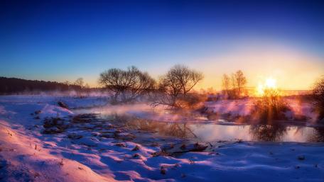 Serene Winter Sunrise Over a Tranquil River Scene wallpaper