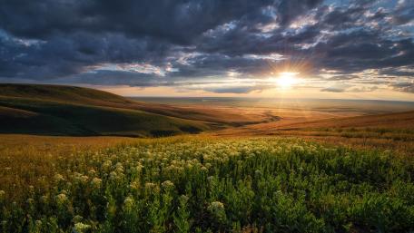 Majestic Sunset Over Tranquil Hillside Fields wallpaper