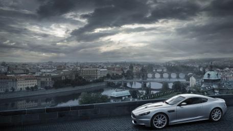 Sleek Silver Car Overlooking a Cityscape wallpaper