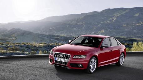 Sleek Audi Standing Proud in Scenic Landscape wallpaper