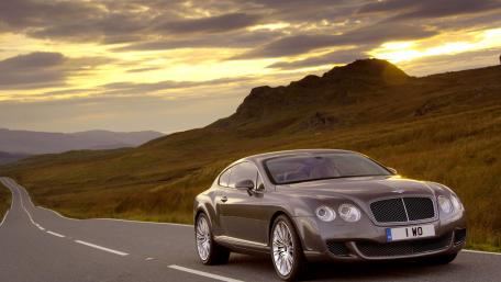 Elegant Car Against a Scenic Sunset Backdrop wallpaper