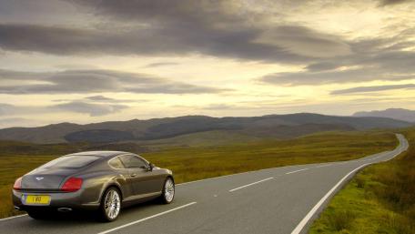 Elegant Bentley on a Serene Open Road wallpaper