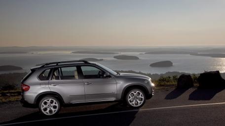 Sleek SUV Against a Serene Landscape wallpaper