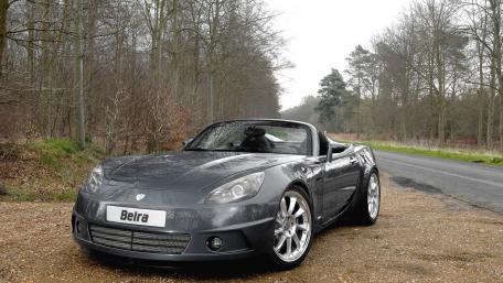 Stylish Convertible on a Scenic Road wallpaper