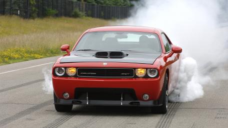 Powerful Red Muscle Car in Action wallpaper