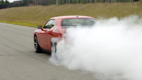 Dynamic Red Muscle Car in Action wallpaper