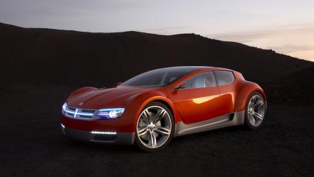 Futuristic Orange Car in a Rugged Landscape wallpaper