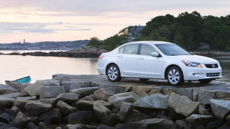 Sleek White Car by the Serene Shoreline wallpaper