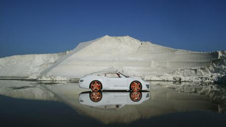Sleek Car In Stunning Landscape Reflection wallpaper