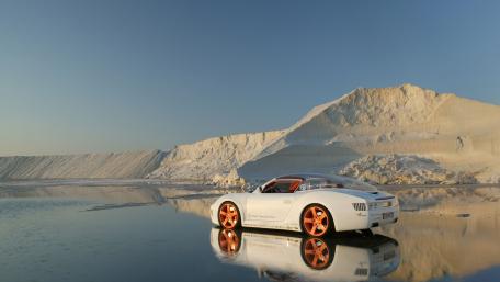 Sleek Sports Car in a Serene Landscape wallpaper