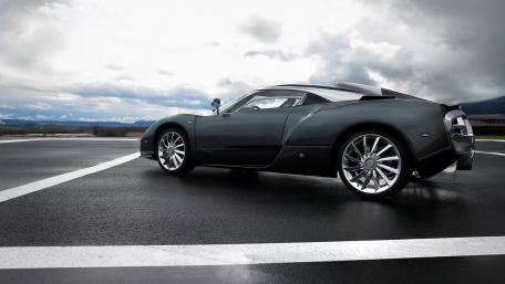 Sleek Luxury Sports Car in Dramatic Landscape wallpaper