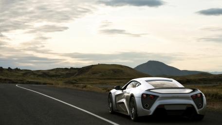 Sleek Silver Sports Car on Open Road wallpaper