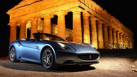 Elegant Ferrari Under Ancient Ruins at Night wallpaper