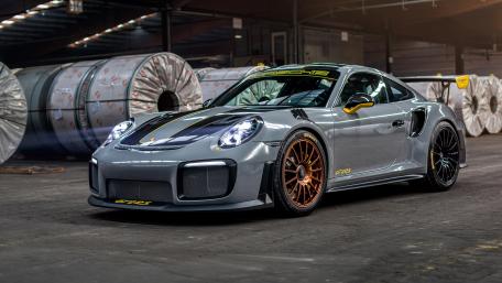 Sleek Porsche GT2 RS in a Modern Warehouse Setting wallpaper