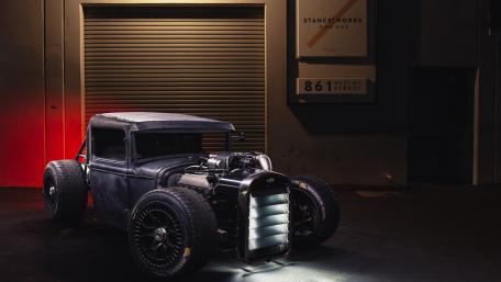 Vintage Car in Urban Garage Setting wallpaper