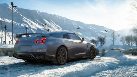 Sleek Car in Winter Landscape wallpaper