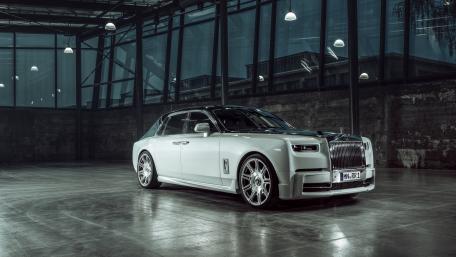 Sleek Luxury Car in Industrial Setting wallpaper