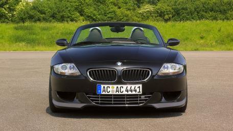 Sleek Black Convertible BMW on Open Road wallpaper