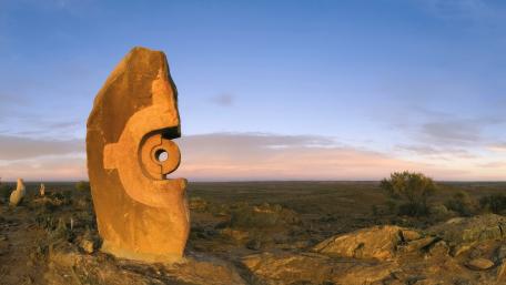 Ancient Rock Art Against a Serene Sky wallpaper
