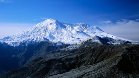 Majestic Snow-Capped Mountains Under Clear Blue Skies wallpaper